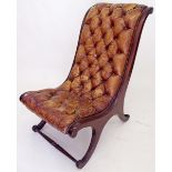 A Victorian leather upholstered slope and scroll back library chair