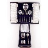 A silver plated dessert cutlery set with cake forks and a christening egg spoon and napkin ring