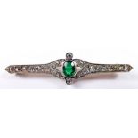 An early 20th century gold brooch set oval cut emerald on diamond set bar, total weight 5.6g