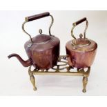 Two copper kettles and a brass trivet