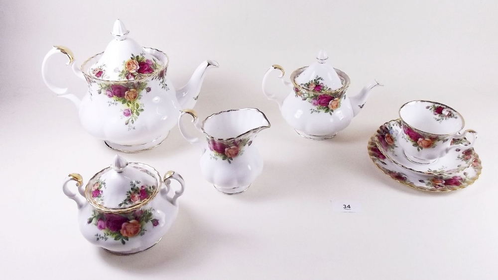 A Royal Albert Country Roses tea service comprising: teapot, small teapot, six cups and saucers, jug