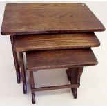 A nest of three oak occasional tables