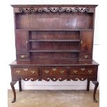 A Queen Anne style oak and elm dresser with scrollwork pierced cornice over three tier back with two