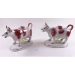 A pair of Staffordshire cow creamers and lids