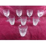 A set of four cut glass wine glasses and four tumblers