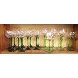 Nine various green stemmed hock glasses and a set of ten green stemmed hock glasses