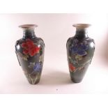 A pair of Victorian tall pottery vases painted flowers