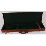 Tan leather and brass mounted motor case, green baize lined fitted interior for 28 ins barrels, with