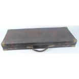 Oak and leather double gun case with brass corners, red baize fitted interior for 30 ins barrels and