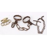 Pair Victorian handcuffs and knuckle duster, East German wrist breaker restraint