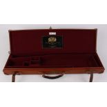 Brady tan leather gun case, red baize lined fitted interior for 28 ins barrels, William Powell & Son