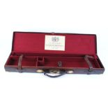 Leather gun case with brass corners, re-lined in red baize, fitted for 30 ins barrels and with