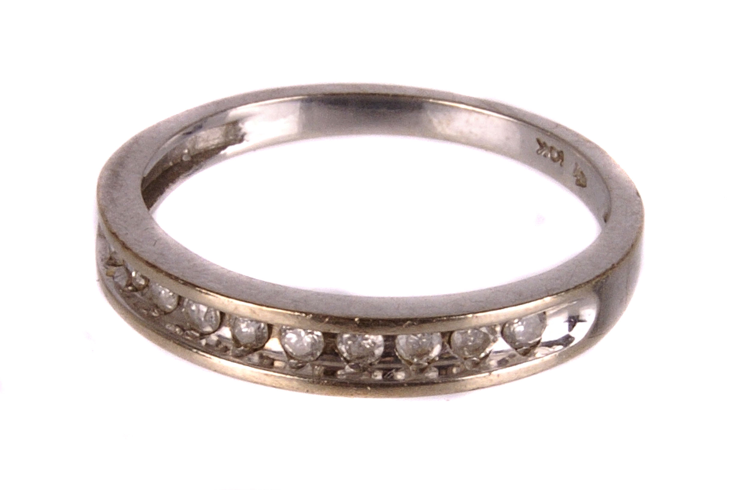 A diamond half eternity ring,  the brilliants deep set in a white gold mount, stamped '10k',