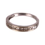 A diamond half eternity ring,  the brilliants deep set in a white gold mount, stamped '10k',