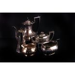 An Edwardian four piece tea and coffee service,  of baluster form with semi gadrooned body, together