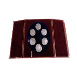 A cased set of modern silver commemorative medallions by John Pinches, the red leatherette case with