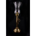 A brass candlestick,  with cut glass storm shade, 54cm high, together with a brass umbrella stand,