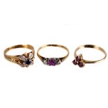 Three 18ct gold and gem set rings,  including a ruby trefoil, a diamond and ruby three-stone, and