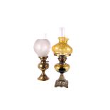 A 19th century parafin lamp, with glass shade and reservoir, on a cast brass base, together with