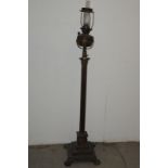 A Victorian brass oil lamp on stand, the Corinthian column base on square stepped plinth having four