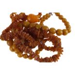 An amber bead necklace,  composed of unpolished amber chips, together with an elasticated amber bead