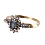 A sapphire and diamond ring,  the central oval cut stone in  a surround of brilliants, to