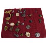 A group of base metal and gilt brooches,  the majority paste set, including a Scottish thistle, a