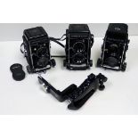 Mamiya C330 Cameras: three examples with 80mm lenses also a prism finder and Mamiya side grip (a