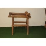 An antique butter table and roller, simple pine construction trestle supporting tray with sides