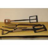 A group of vintage farm forks and digging tools, including two pierced spade shovels, an F. Parkes &