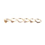 A diamond love token ring,  the heart motif asymmetrically set with a row of diamonds, the 18ct gold