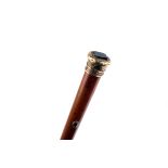 A Victorian gold mounted malacca walking cane,  the scroll engraved gold cap set with a smoky