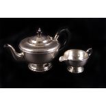 A George V silver circular teapot by Marson & Jones,  Birmingham 1932, with ebonised hoop handle and