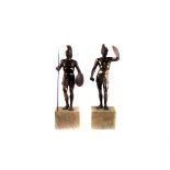 A pair of spelter figures of Roman warriors, one armed with a spear and shield, the other with a
