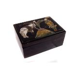 A Japanese black lacquered papier mache box,  with tethered horse and warrior motif composed of