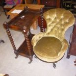 A late Victorian ebonised deep buttoned nursing chair,  on gilt edged scroll feet to porcelain