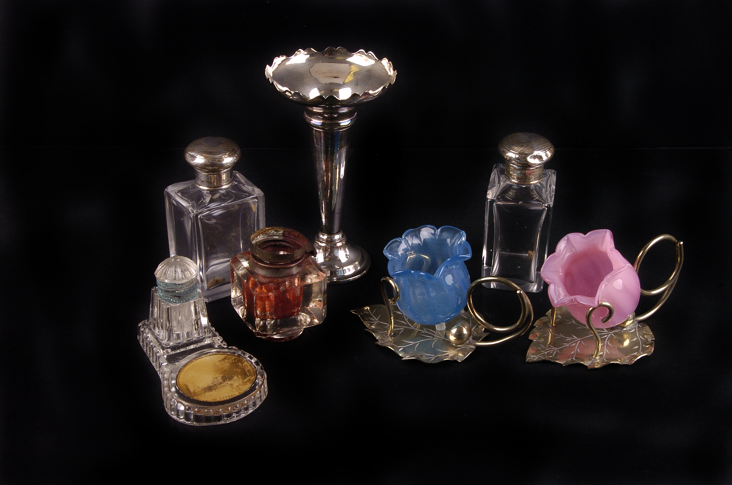 A silver and silver plate mounted glassware,  including a pair of toiletry bottles, a spill vase,