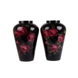 A pair of vintage large glass vases, the black painted and rose internally decorated baluster