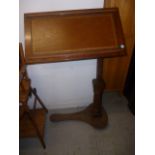 A Victorian walnut book table,  with tilting, leathered top, and gun barrel column, over a