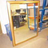 A large gilt framed wall mirror, having bevelled glass, approx. 88cm by 116cm