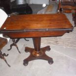 A William IV rosewood fold over card table, with gun barrel pedestal and lappet carved quadripartite