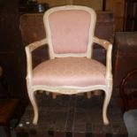 A modern French style cameo back armchair,  the cream painted beech frame upholstered in pink damask