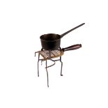 A copper monopod coal scuttle, three brass hearth pans raised on feet, a brass step trivet, and a
