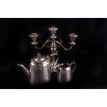 A small group of electroplated items,  including a teapot and cream jug en suite, three arm
