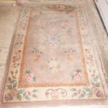 A modern Chinese rectangular rug,  with soft brown field and inset cream border, floral design