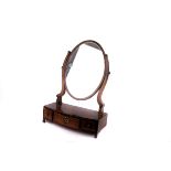 An Victorian mahogany swing frame oval toilet mirror,  with three compartment base, the mirror