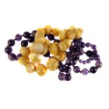 A yellow amber bead necklace, composed of graduated polished beads, 67g, together with an amethyst