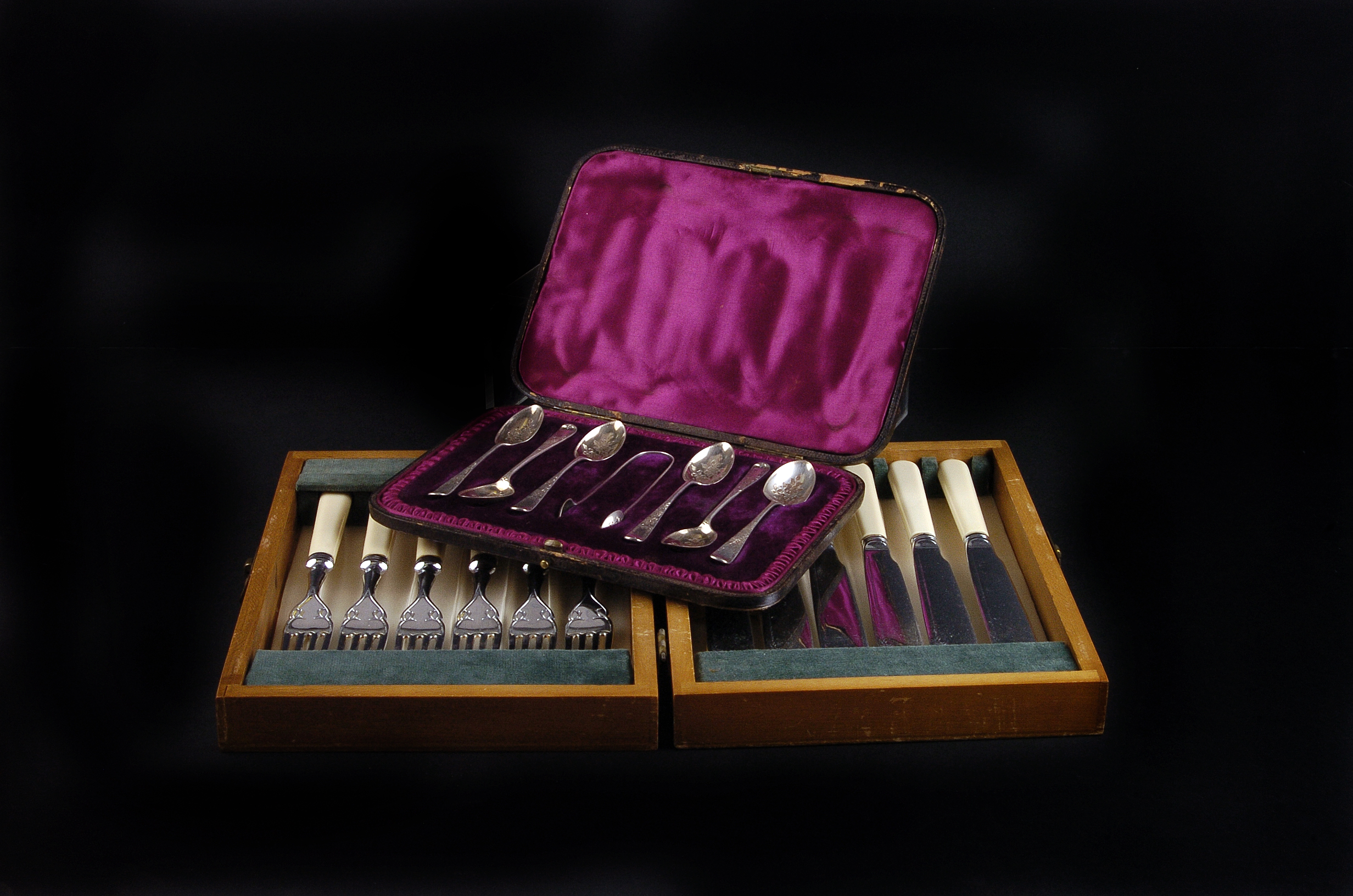 A collection of silver plated services,  in their canteens, together with a set of silver bright cut