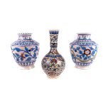 A matched pair of Iznik pottery vases,  the flattened ovoid body with white ground, beneath