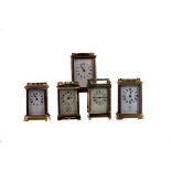 A group of five antique and vintage brass carriage timepieces, in varying designs and conditions,